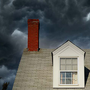 Close up of a home with dark clouds in the background